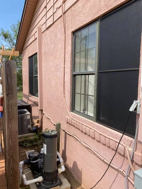 Rear elevation of a pool home with solar screens installed