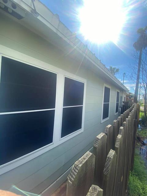 Siding home with solar screens on every window
