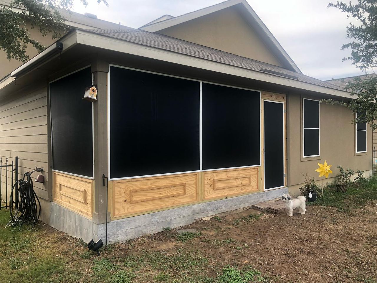 Screened patio enclosure with black solar screen panels
